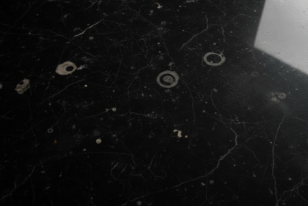 Close-up of a dull etch mark on a polished marble surface